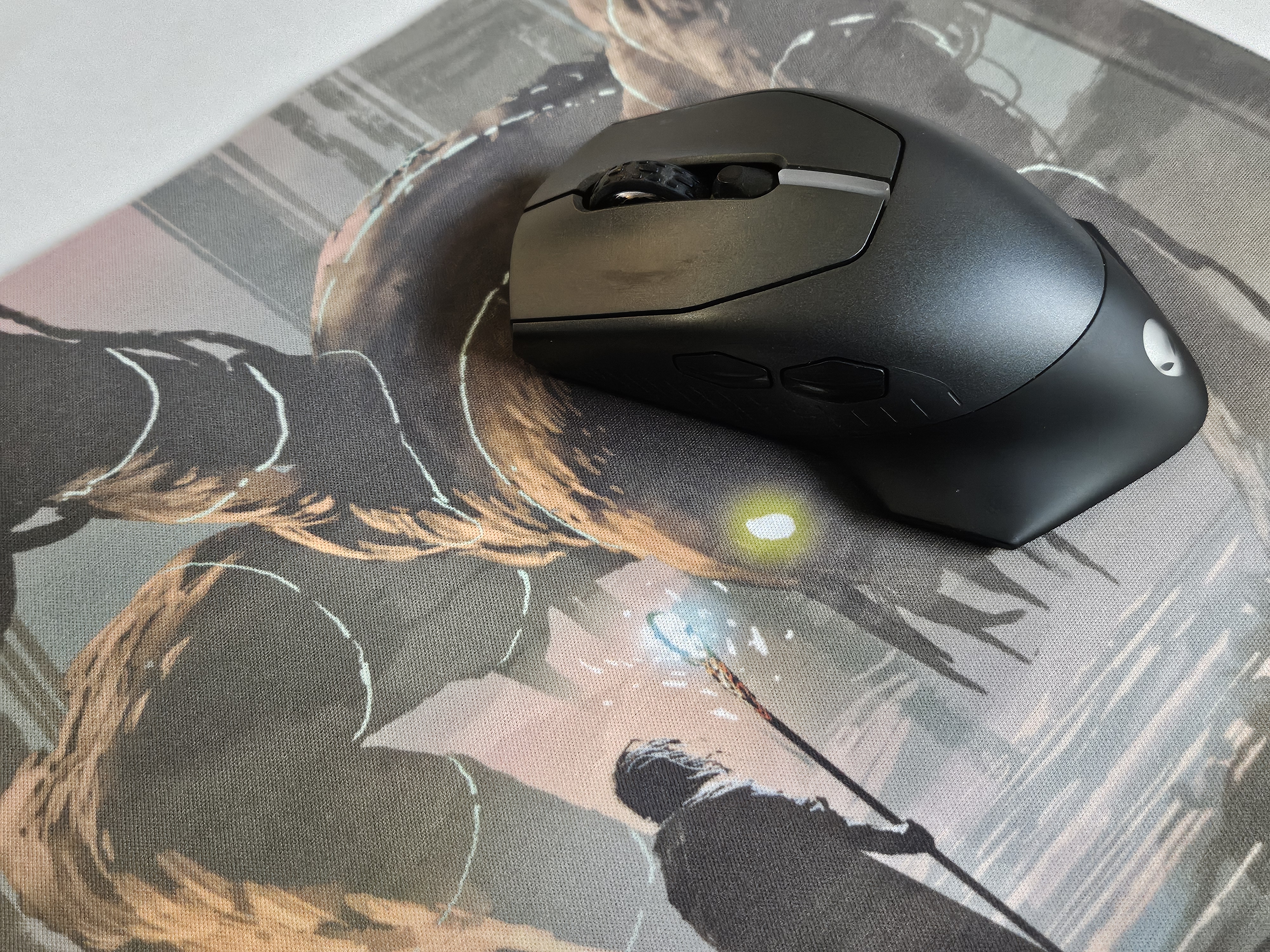 Custom mouse pad printed with anime artwork under a gaming mouse on a desk