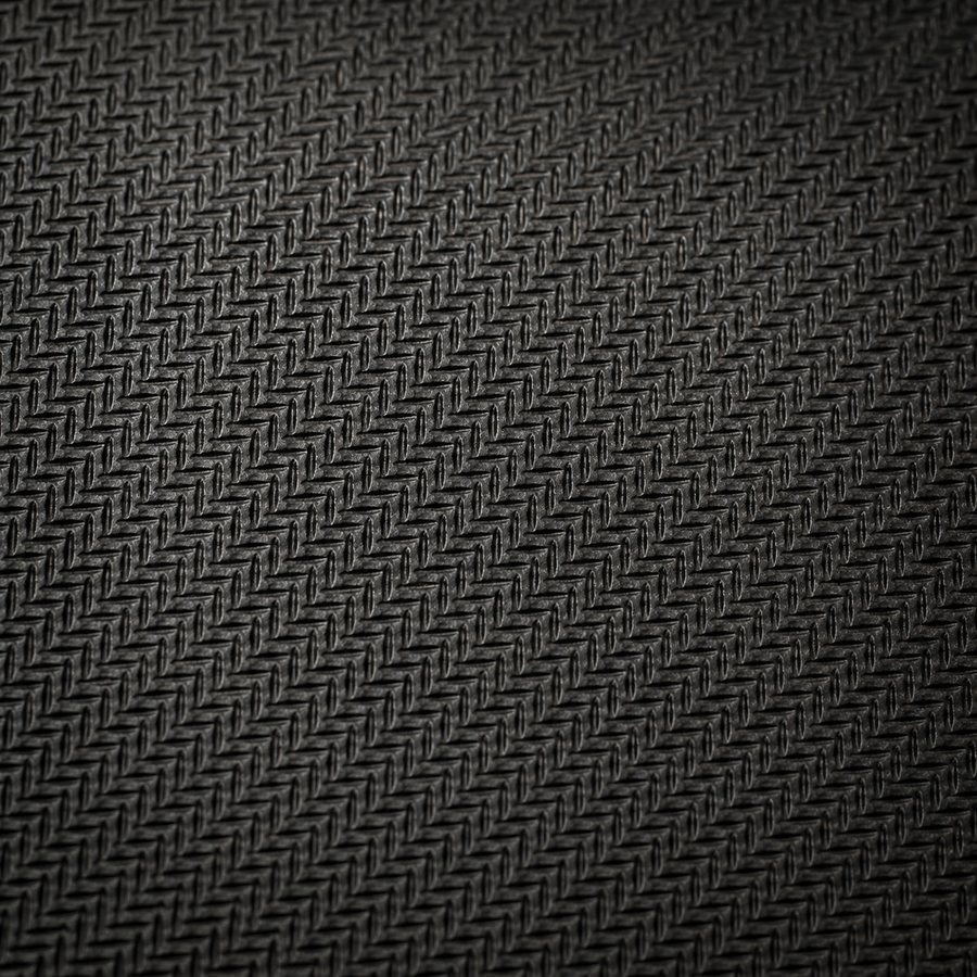 Close-up of the textured non-slip natural rubber base of a custom desk mat
