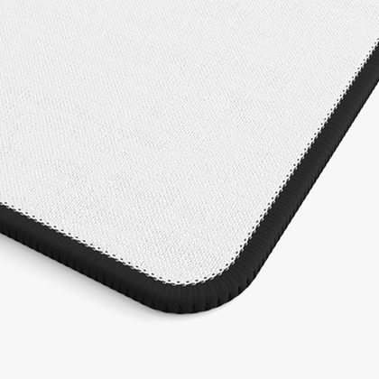 Corner of a desk mat with a black sewn stitched border